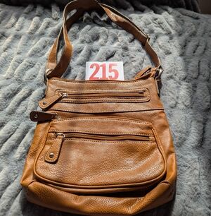 Lot 215 Brown leather crossbody sling bag designed for everyday use and travel. 